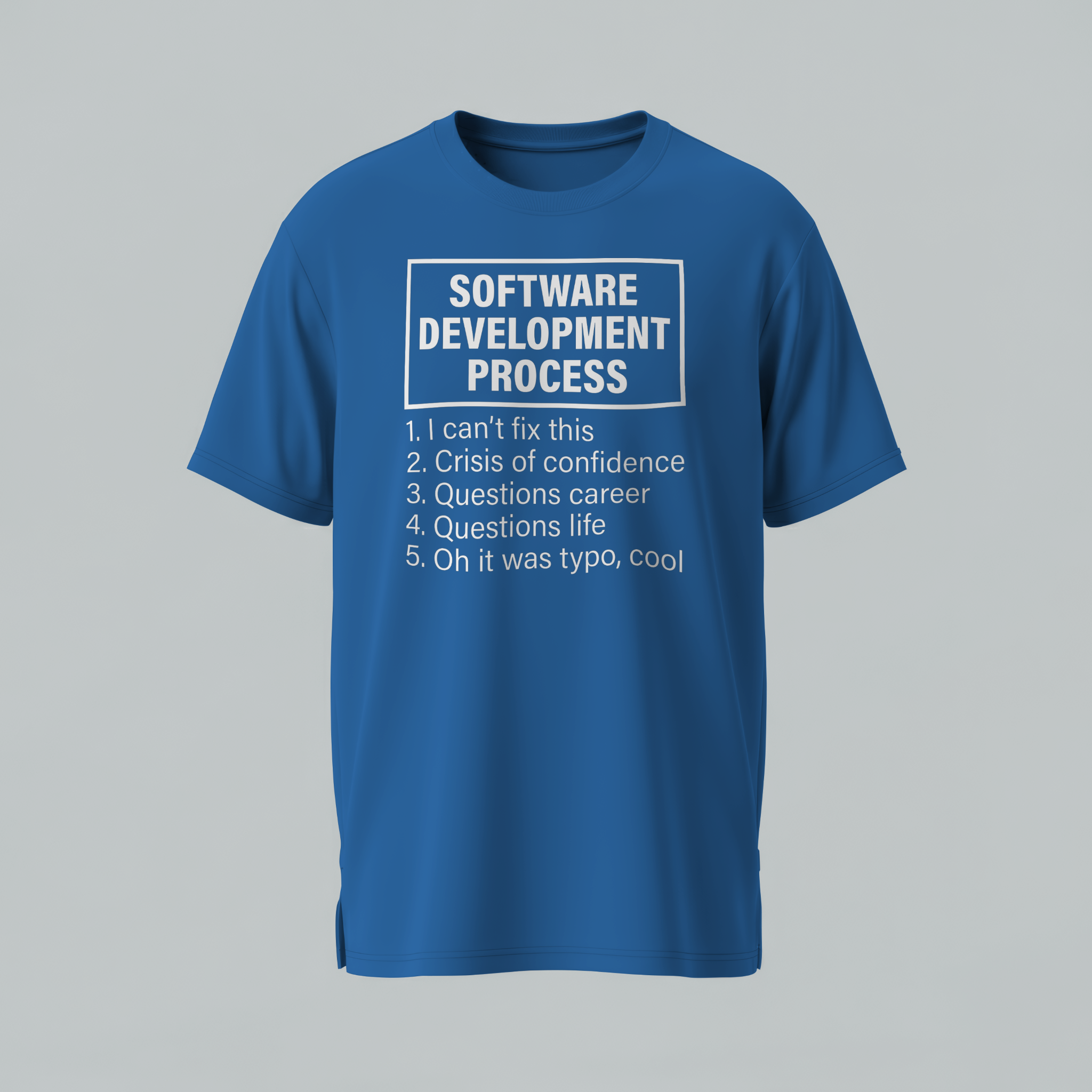 Blue t-shirt with text about software development process on a gray background