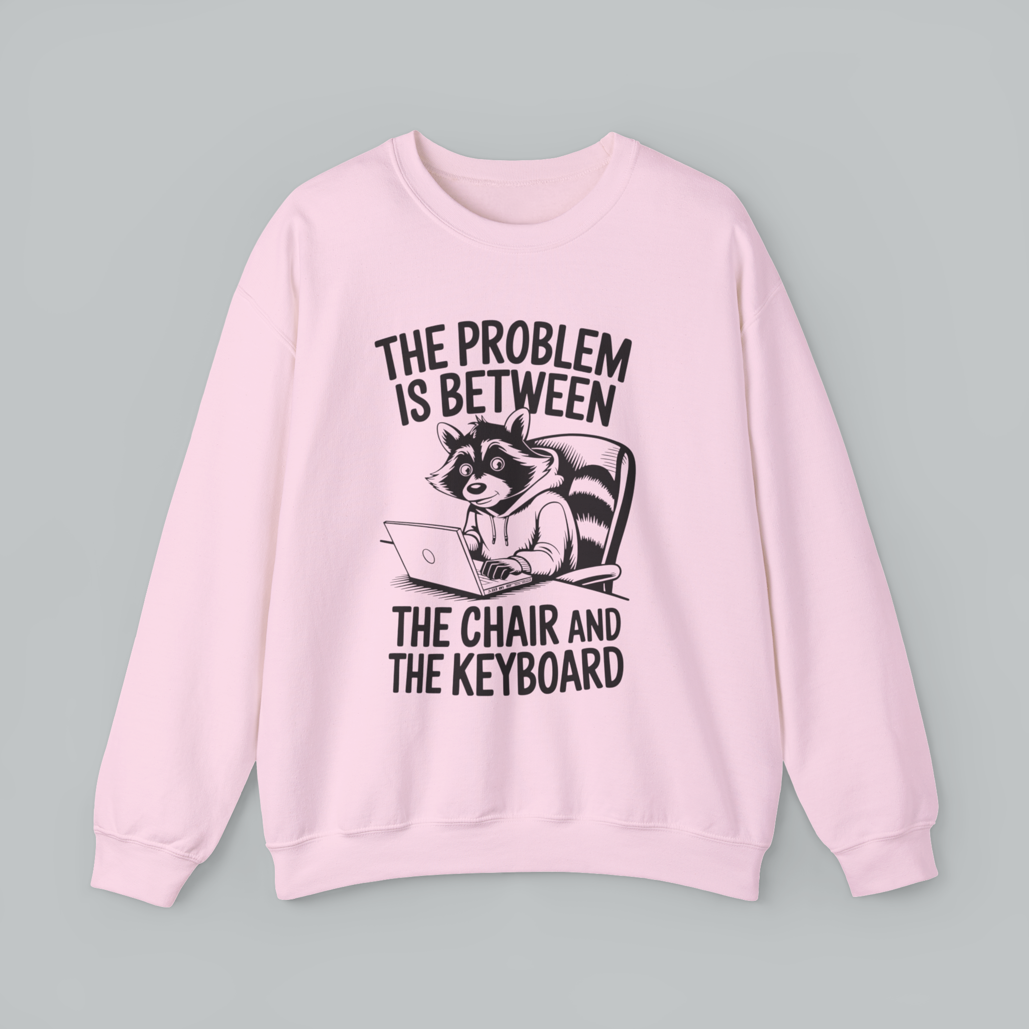 Pink sweatshirt with a raccoon graphic and text on a gray background